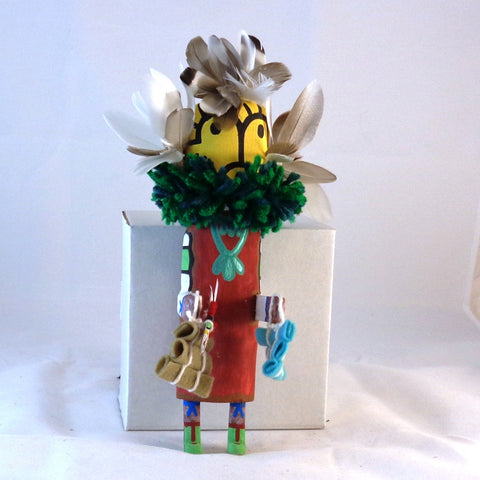 Qoqole (Yellow) giving gifts kachina